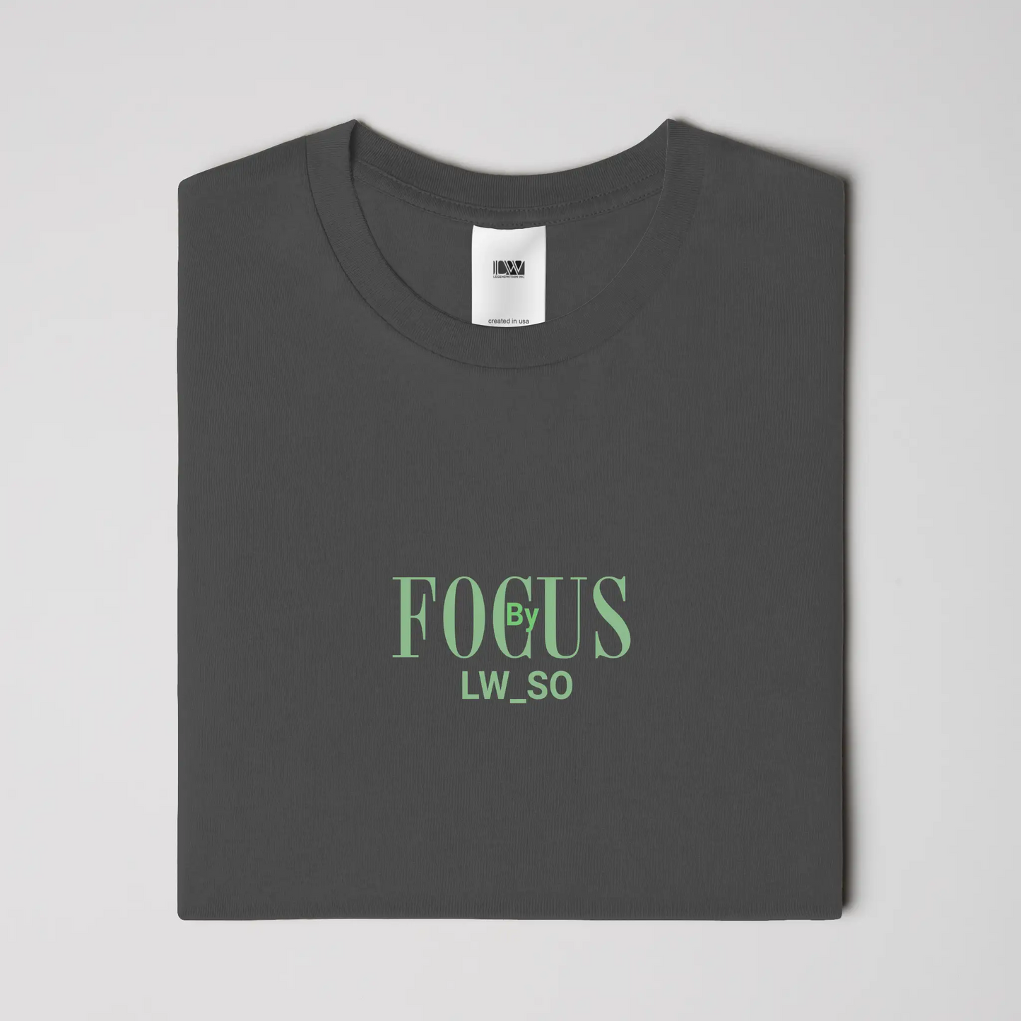 Folded charcoal Focus by LWSO Epic T-Shirt with green text logo on chest in modern fit design
