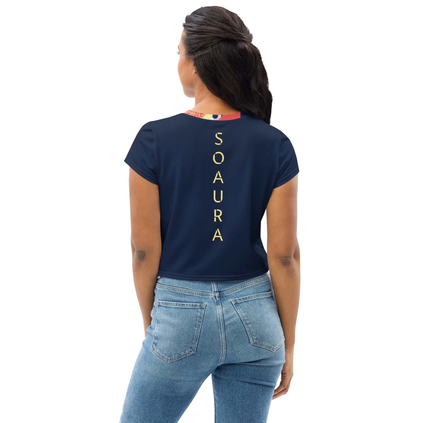 Woman wearing navy blue 90's inspired crop tee with vertical "SOAURA" text on the back paired with light blue jeans.