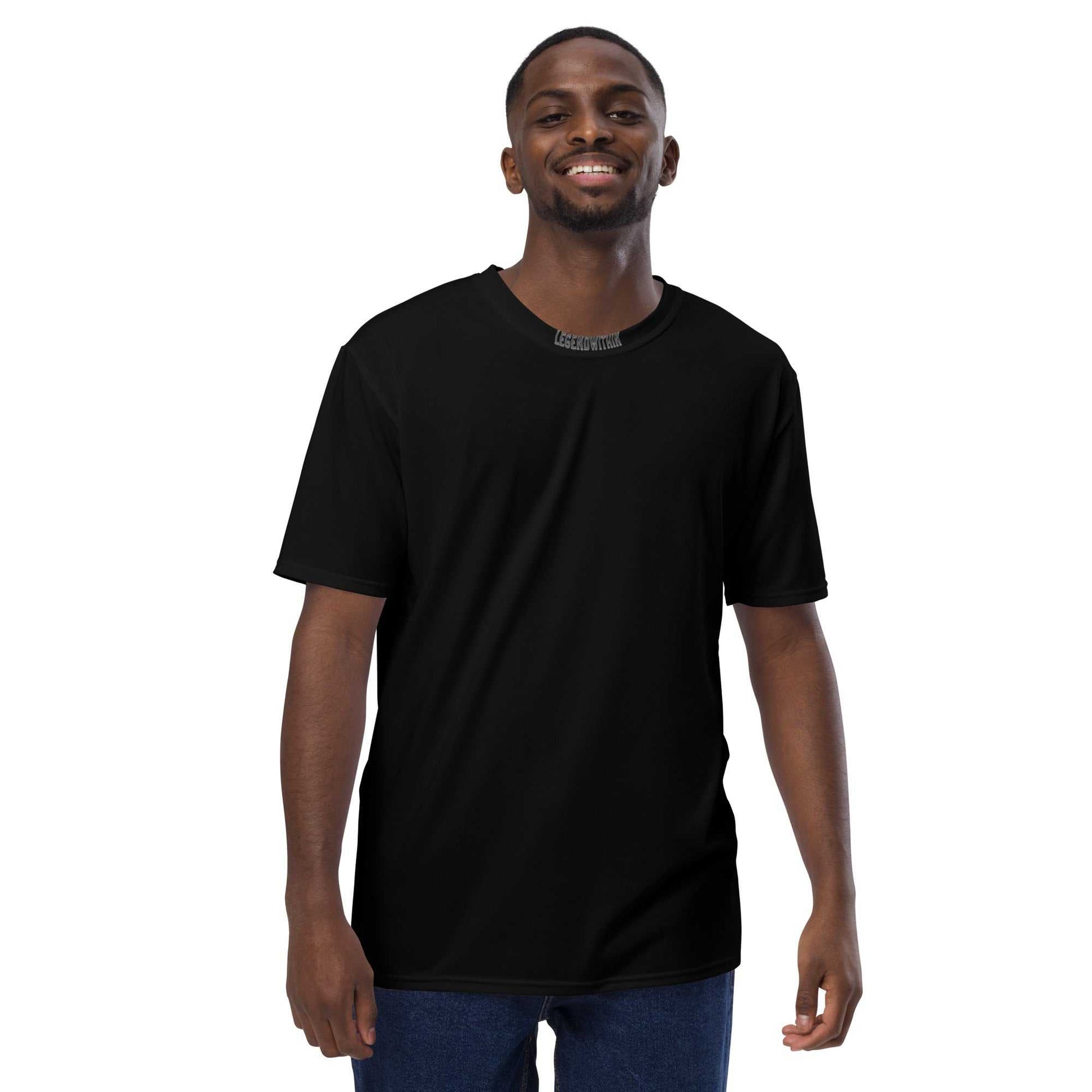 Man wearing a black LegendWithin Men's t-shirt made of smooth, comfortable cotton touch polyester jersey with regular fit and two-way stretch fabric.