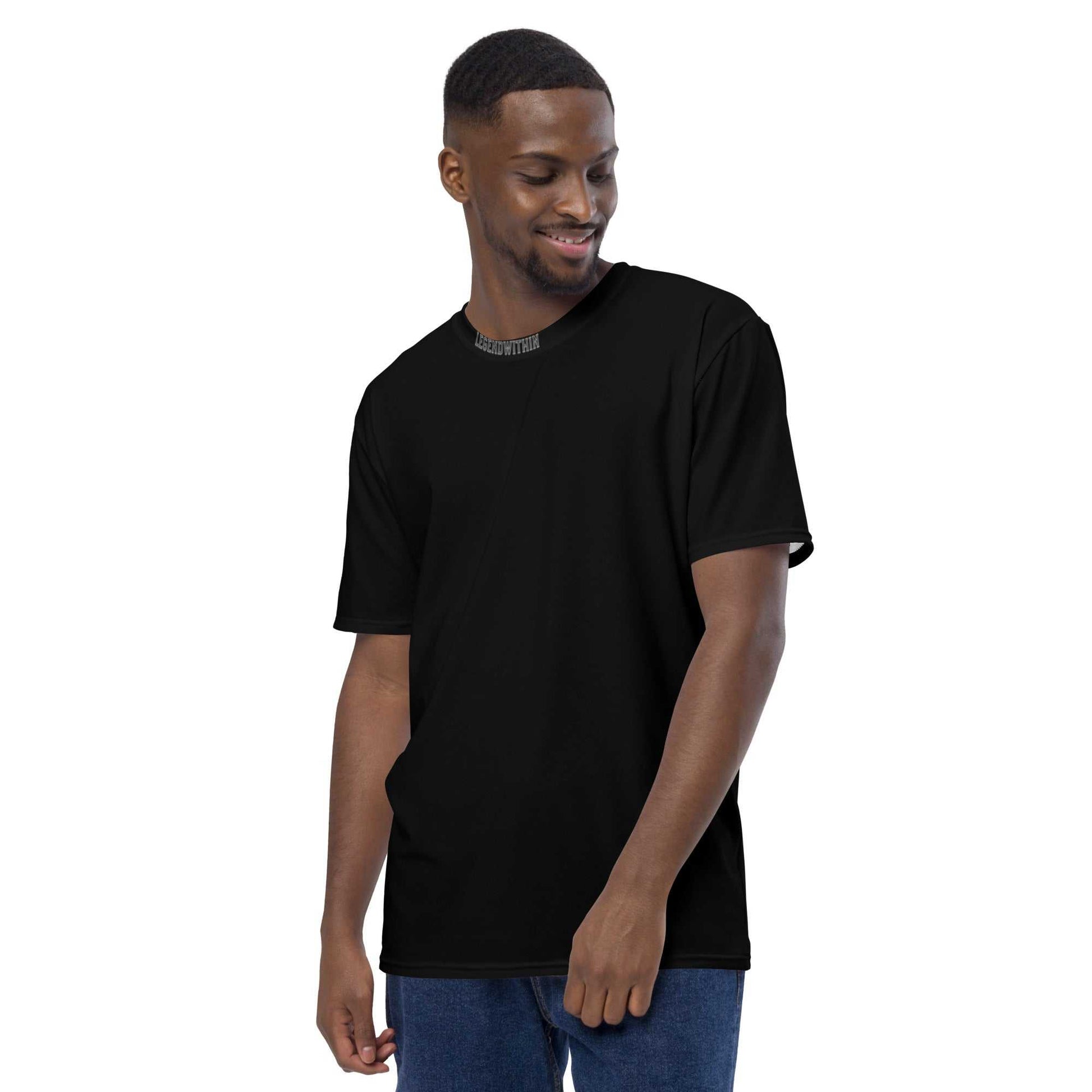 Man wearing a black LegendWithin Men's t-shirt made of smooth, comfortable cotton touch polyester jersey with regular fit and 2-way stretch fabric