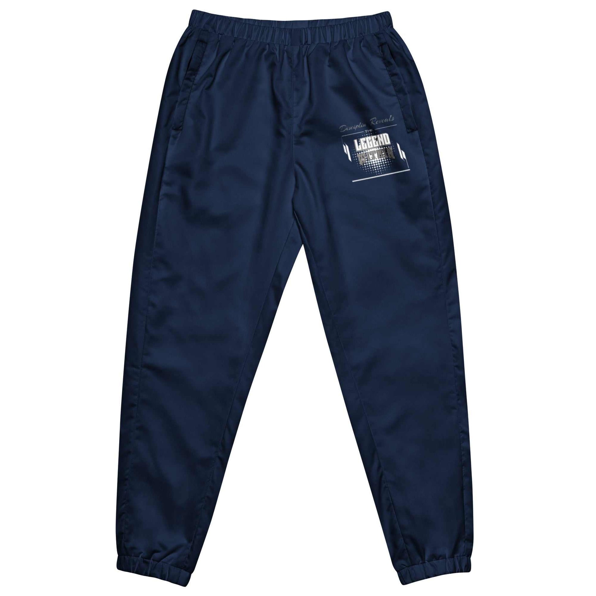 LegendWithin track pants in navy blue with elastic waistband and ankle cuffs, zip pockets, lightweight water-resistant fabric, and mesh lining.